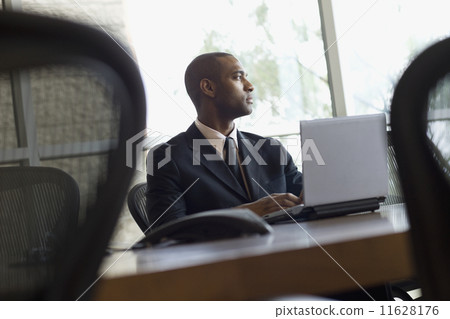 African businessman typing on laptop 11628176