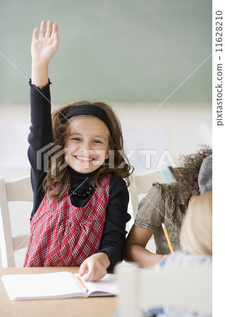 Girl raising hand in class Girl raising hand in class 11628210