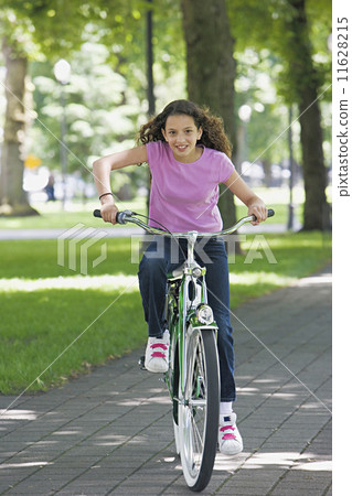 Young girl riding a bike 11628215