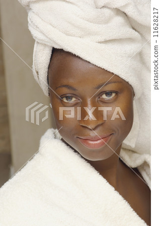 Close up of African American woman wearing bathrobe 11628217