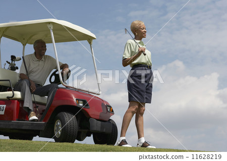Senior African American couple with golf cart 11628219