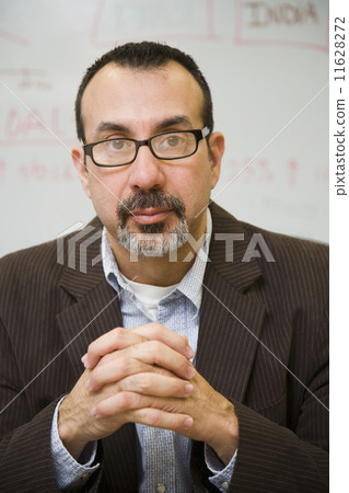 Hispanic businessman with hands clasped 11628272