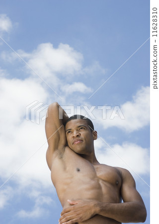 Bare-chested African man holding arm behind head 11628310