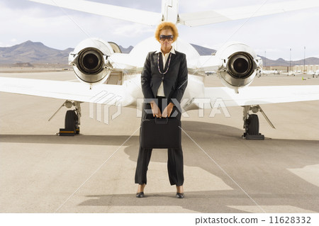 African American businesswoman in front of airplane 11628332