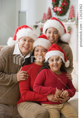 Hispanic family wearing Santa Claus hats Hispanic family wearing Santa Claus hats 11628362