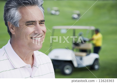 Man in front of golf cart Man in front of golf cart 11628363