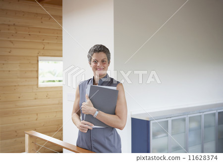 Mixed Race businesswoman holding paperwork  11628374