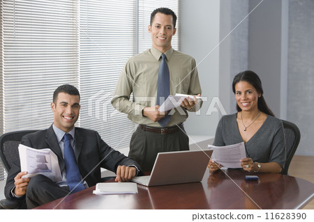 Hispanic businesspeople in conference room 11628390