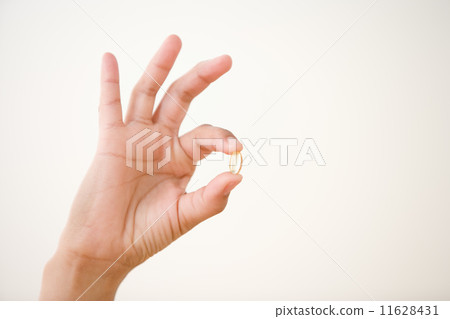 Close up of hand holding vitamin Close up of hand holding vitamin 11628431