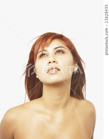 Asian woman with bare shoulders looking up 11628435