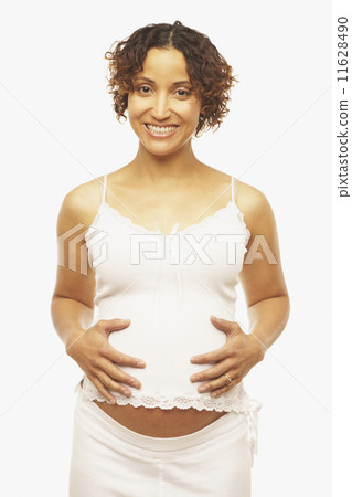 Pregnant Mixed Race woman with hands on belly 11628490
