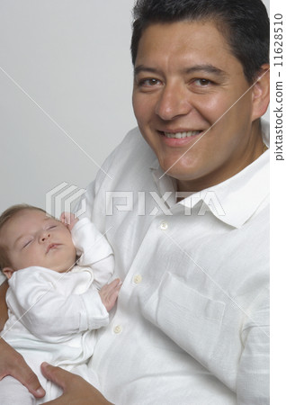 Hispanic father holding baby 11628510