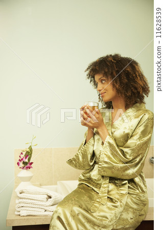 African American woman sitting on bathtub African American woman sitting on bathtub 11628539