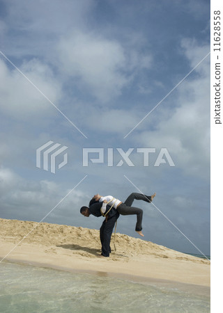 Multi-ethnic businesspeople tied together at beach 11628558
