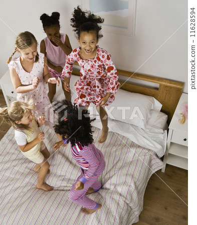 Multi-ethnic girls having slumber party 11628594