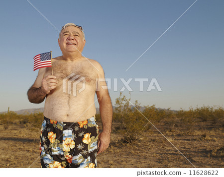 Senior Mixed Race man wearing bathing suit in desert 11628622