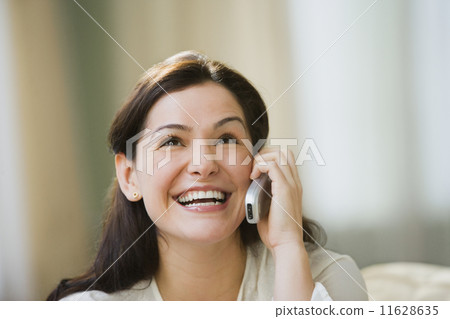 Hispanic woman talking on cell phone Hispanic woman talking on cell phone 11628635