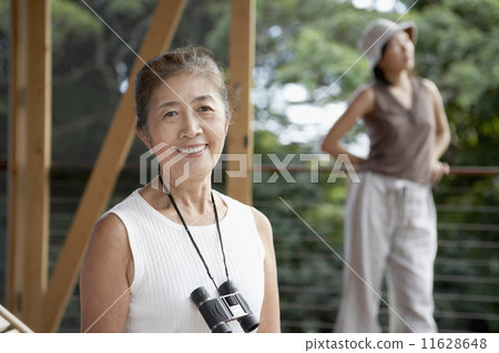 Senior Asian woman with binoculars Senior Asian woman with binoculars 11628648