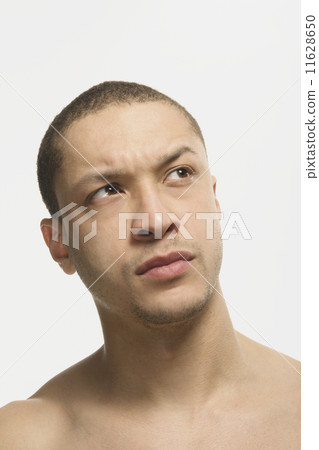 Mixed Race man looking skeptical Mixed Race man looking skeptical 11628650