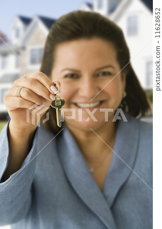Hispanic woman holding house key Hispanic woman holding house key 11628652