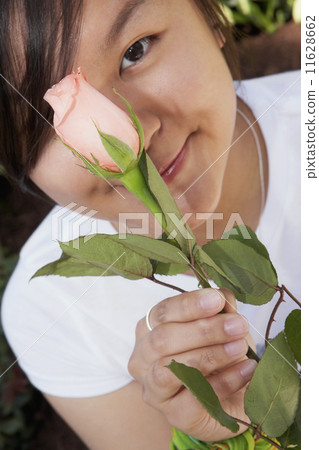 Asian woman holding flower 11628662