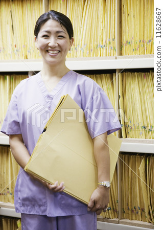 Portrait of female technician holding x-rays Portrait of female technician holding x-rays 11628667