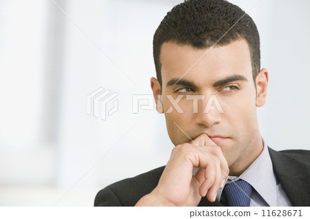 Hispanic businessman thinking 11628671
