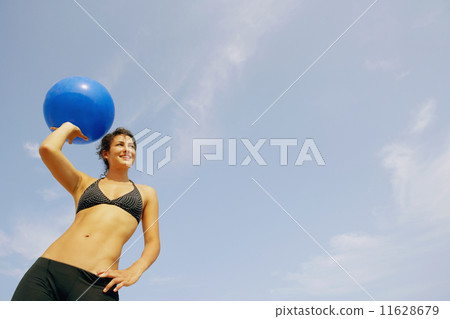 Young woman holding beach ball 11628679