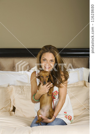 Hispanic woman hugging dog Hispanic woman hugging dog 11628680