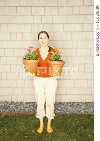 Asian woman holding potted plants Asian woman holding potted plants 11628696