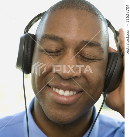 African man listening to headphones African man listening to headphones 11628704