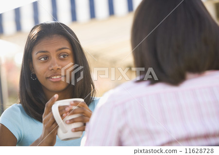 African teenaged girl talking to friend 11628728