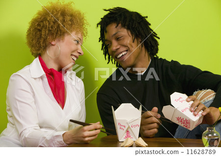 African couple eating takeout food African couple eating takeout food 11628789