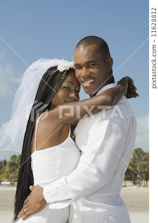 African bride and groom hugging 11628812