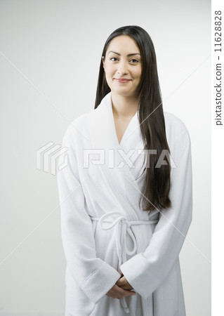 Hispanic woman wearing bathrobe 11628828
