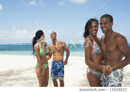 Multi-ethnic couples dancing on beach Multi-ethnic couples dancing on beach 11628832