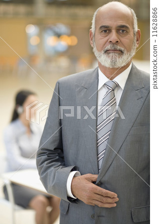 Senior African businessman with hand on jacket 11628866