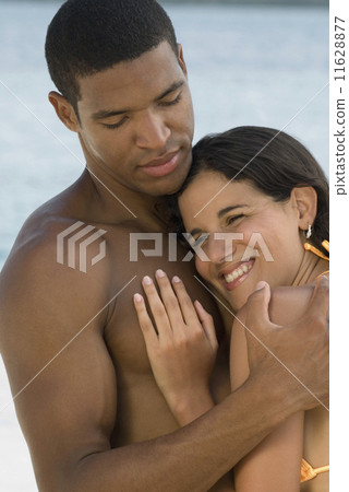 Hispanic couple hugging 11628877