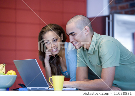 African American couple looking at laptop 11628881