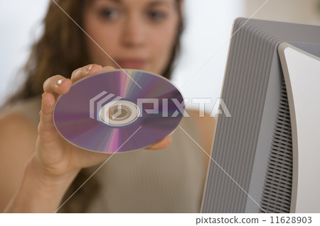 Hispanic woman holding up cd Hispanic woman holding up cd 11628903