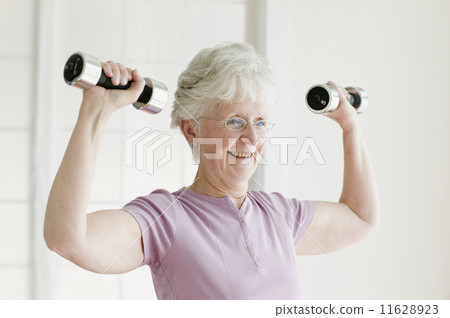 Senior woman lifting free weights Senior woman lifting free weights 11628923