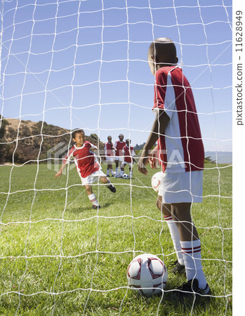 Multi-ethnic children playing soccer 11628949