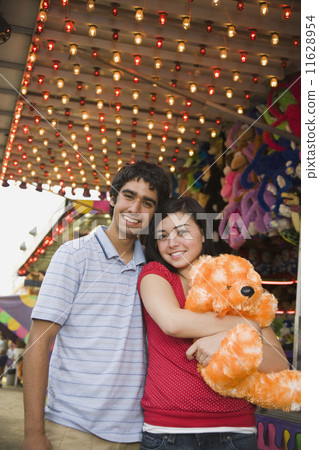 Multi-ethnic teenaged couple at carnival Multi-ethnic teenaged couple at carnival 11628954
