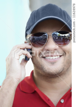 Hispanic man talking on cell phone 11628978