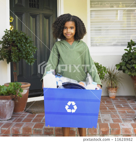 African girl holding recycling bin 11628982