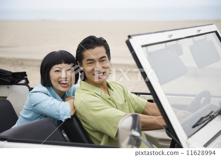 Asian couple in convertible 11628994
