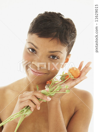 African American woman holding flowers African American woman holding flowers 11629015