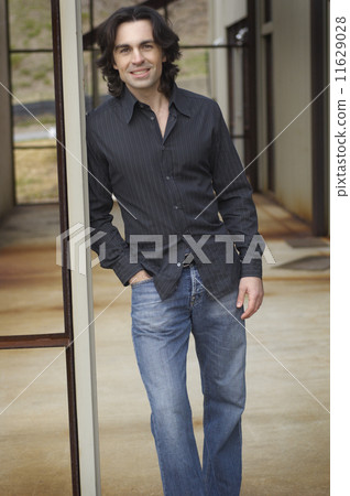 Portrait of man standing in doorway Portrait of man standing in doorway 11629028