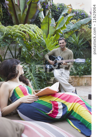 Multi-ethnic couple relaxing outdoors 11629064