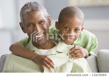 African American grandfather and grandson hugging 11629069